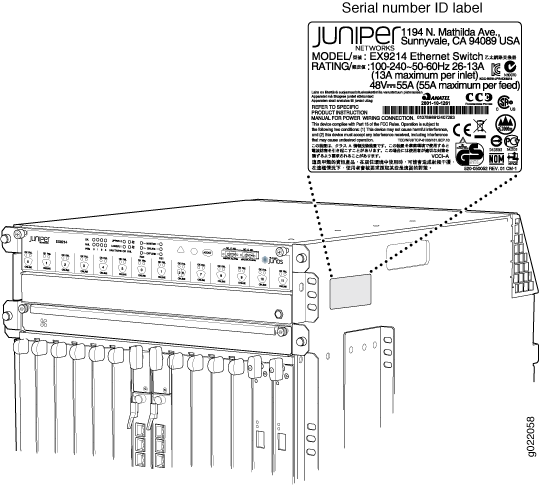 Juniper Networks EX9214 Ethernet Switch with visible serial number ID label showing model number, power ratings, and compliance certifications.
