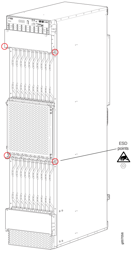 Technical drawing of a Juniper Networks router chassis with slots for line cards, power supplies, cooling systems, and marked ESD grounding point.