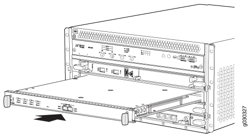 Inserting a line card into a Juniper Networks router chassis for added network interfaces.