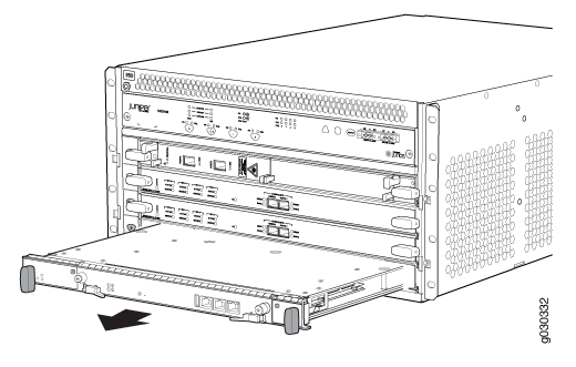 Juniper Networks chassis with a line card being inserted. Arrow indicates module movement direction.