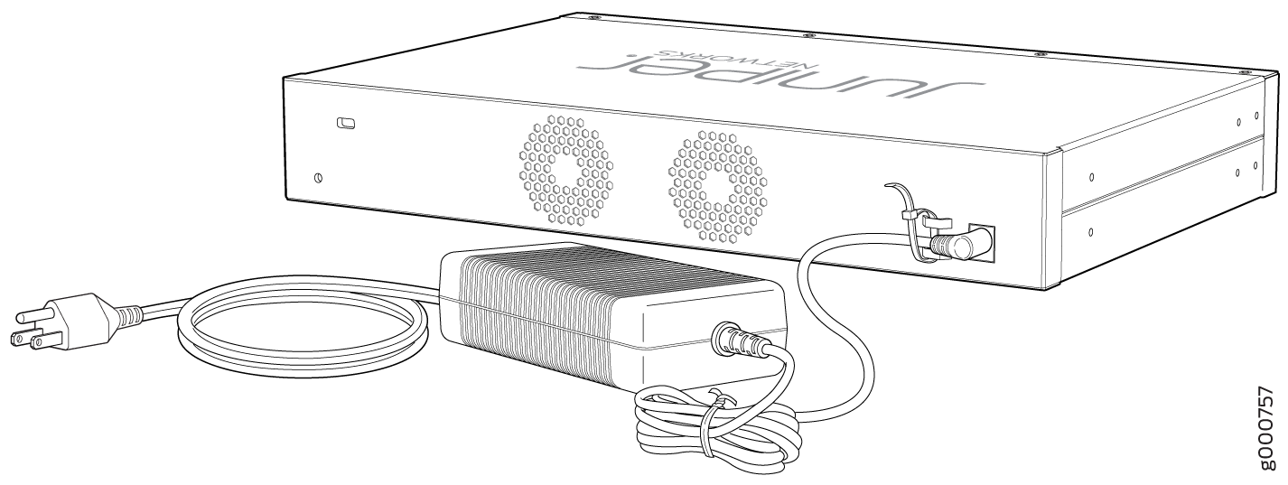 Juniper Networks device connected to a power adapter and power cord in a data center setting.
