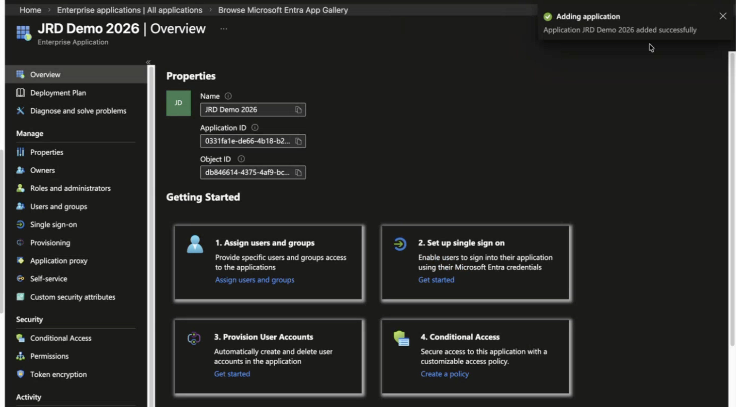Microsoft Entra Admin Center overview page for enterprise app JRD Demo 2026, showing app details, navigation panel, setup steps, and success notification for app addition.