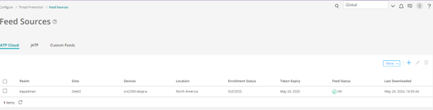 Feed Sources page in cybersecurity software showing ATP Cloud tab with realm bagelman, site Site1, device vmx200-1 at spoke, location North America, enrollment status SUCCESS, token expiry May 24 2025, feed status OK with green checkmark, last downloaded May 24 2024. Options to add or edit feed sources are available.